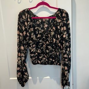 Black floral top with front ruching and wide tapered sleeves